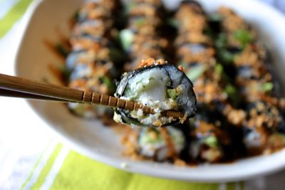 High angle view of chopsticks with sushi over table