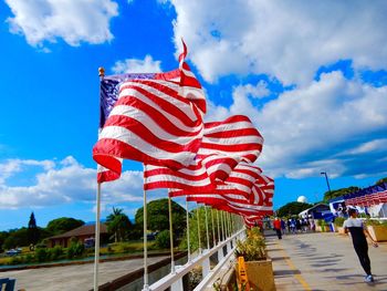 American flags waving against sky