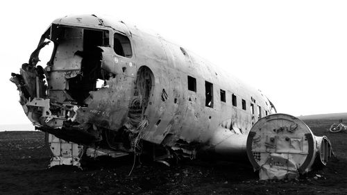 Abandoned airplane against sky
