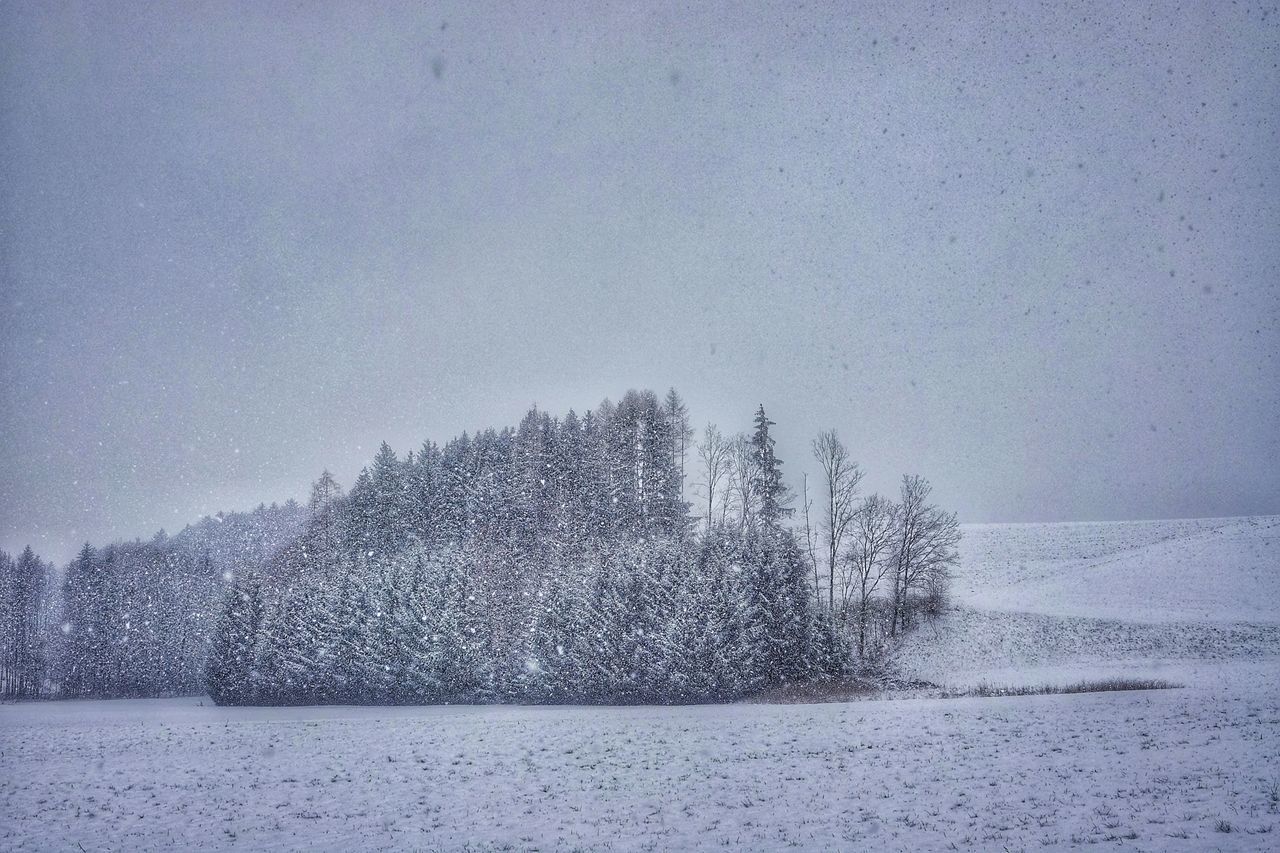 SNOW COVERED LAND AGAINST SKY