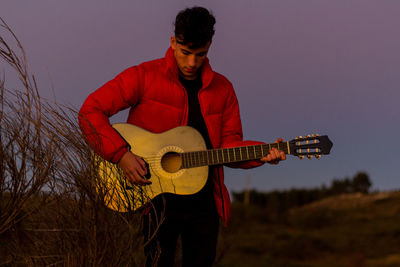 Full length of man playing guitar