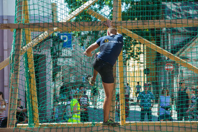 Low angle view of man on metal structure