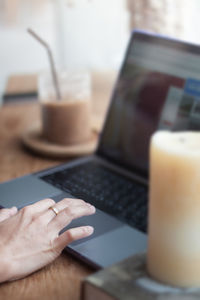 Midsection of man using mobile phone on table