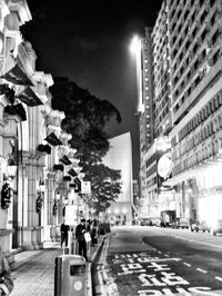 City street amidst buildings at night