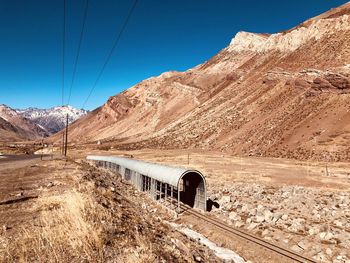 Scenic view of mountains against clear blue sky