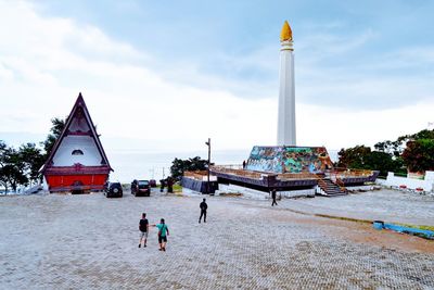 People on beach against sky