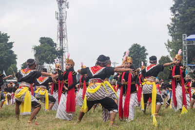 People on field against sky