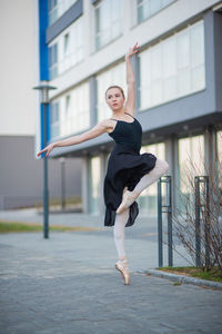Full length of young woman jumping
