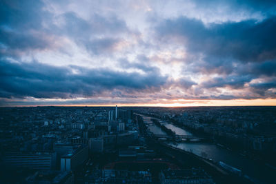 View of cityscape against cloudy sky