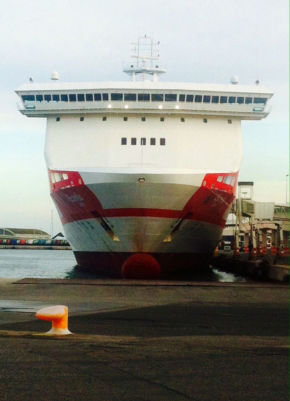 transportation, mode of transport, architecture, built structure, building exterior, nautical vessel, sky, travel, city, boat, clear sky, moored, outdoors, flag, harbor, day, water, incidental people, car, travel destinations