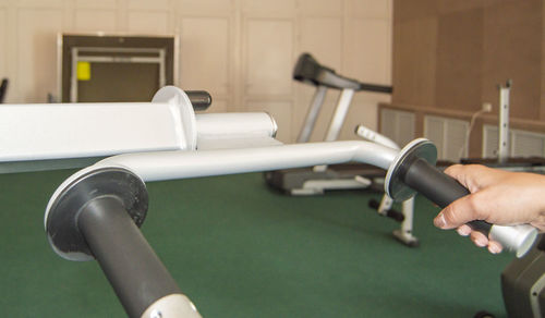 Cropped image of man exercising in gym