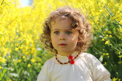 Portrait of cute girl with yellow flowers