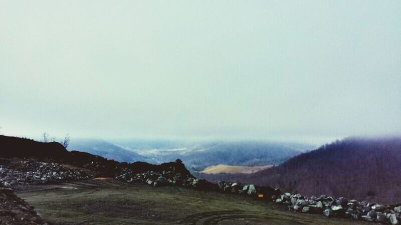 mountain, mountain range, scenics, tranquil scene, tranquility, landscape, beauty in nature, fog, weather, nature, copy space, non-urban scene, sky, winter, remote, idyllic, snow, foggy, outdoors, cold temperature