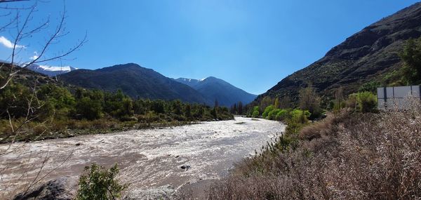 Scenic view of landscape and mountains against clear blue sky