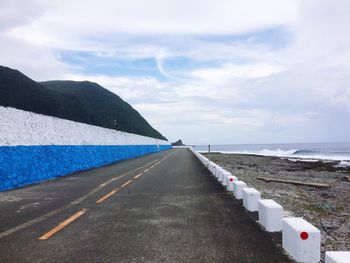 Road by sea against sky