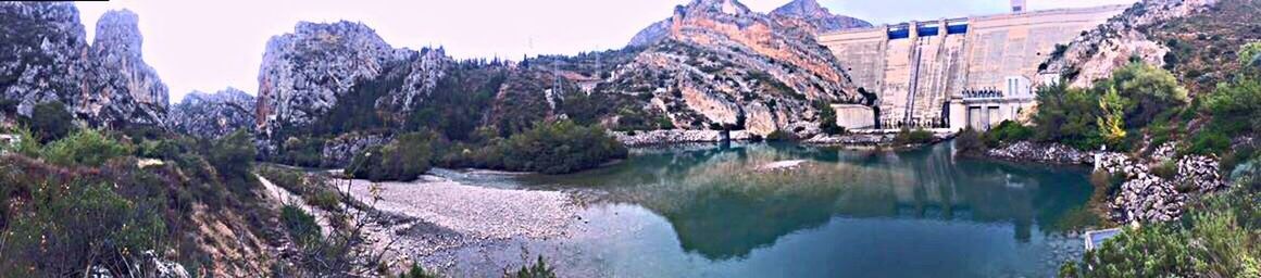 Panoramic view of river amidst trees against sky