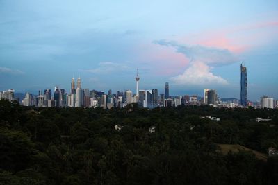 Panoramic view of buildings in city against sky