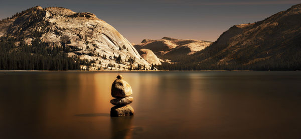 Reflection of mountain range in lake at sunset