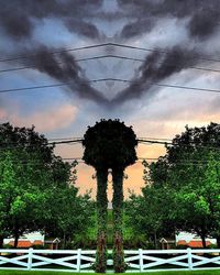 Low angle view of power lines against cloudy sky