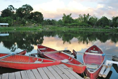 Boats at lake against sky