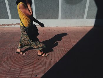 Low section of woman standing on tiled floor