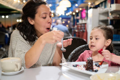 Young woman having food at restaurant