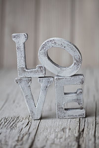 Close-up of white love text on wooden table