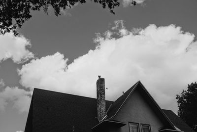 Low angle view of buildings against cloudy sky