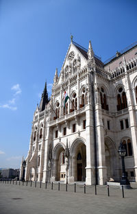 Low angle view of historical building against blue sky