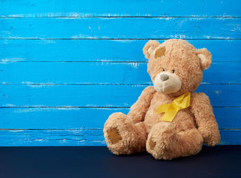 Stuffed toy on wood against wall