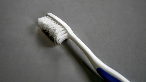 High angle view of toothbrush against gray background