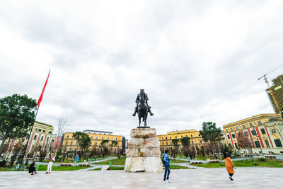 Statue of historic building against sky in city