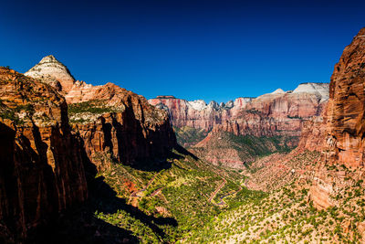 Rock formations on landscape against blue sky