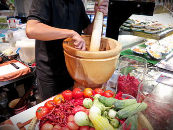 Midsection of man for sale at market stall