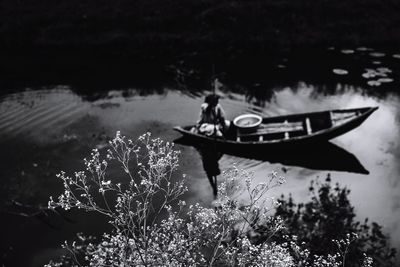 Rear view of man in boat on lake