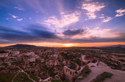 View of cityscape against cloudy sky