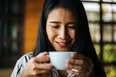 Portrait of a woman drinking coffee