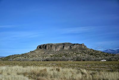 Scenic view of landscape against blue sky