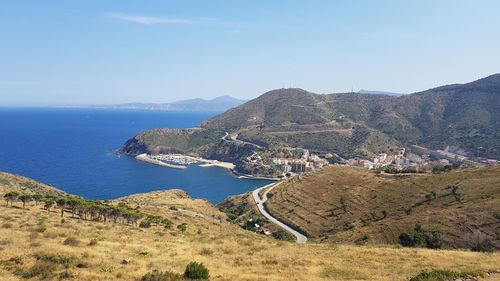 Scenic view of sea and mountains against sky