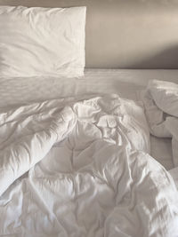 White pillow and bed duvet cover in bedroom