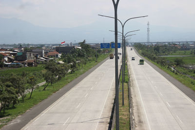 High angle view of road by city against sky