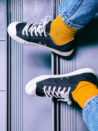 Low section of person wearing canvas shoes