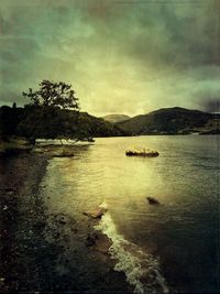 Scenic view of lake and mountains against sky