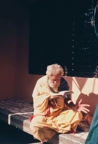 Man reading on bed at street 