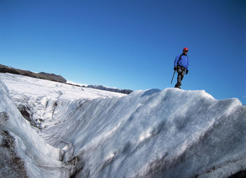 Man exploring the glacier solheimajokull in iceland