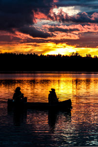 Scenic view of lake against orange sky