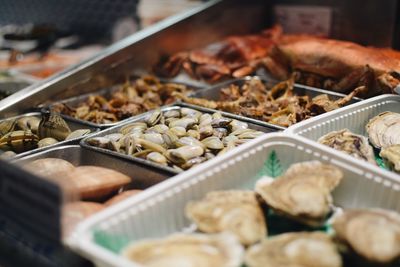 Close-up of fresh seafood in containers at market stall