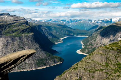 Scenic view of sea and mountains against sky