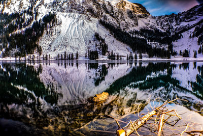 Scenic view of lake and snowcapped mountains during winter