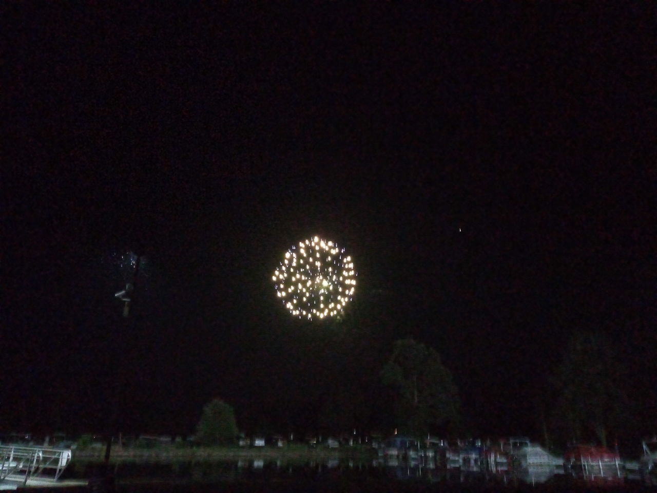 LOW ANGLE VIEW OF FIREWORKS AT NIGHT